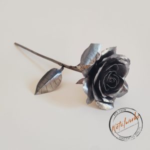 Handcrafted metal rose with detailed petals and a sculpted stem, showcasing artisanal craftsmanship and a timeless, decorative design.