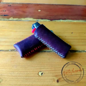 Close-up of a durable, hand stitched leather lighter cover, showcasing the artisanal detail.